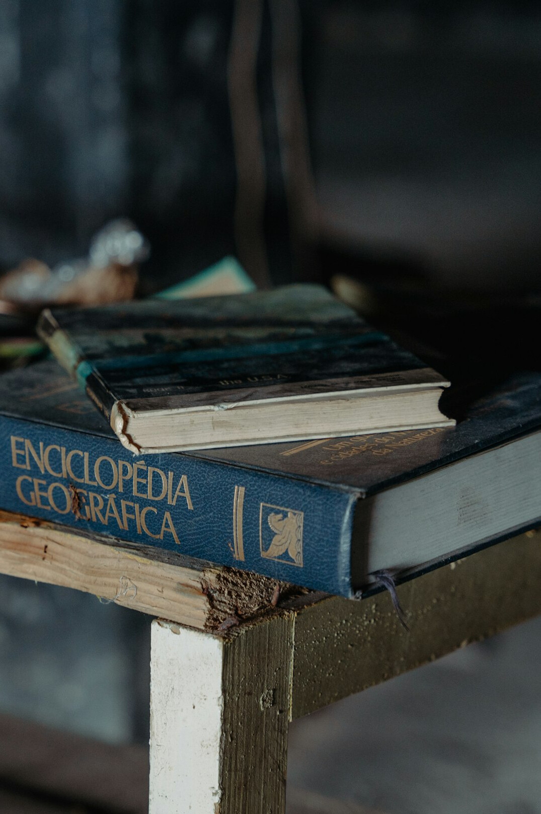Stack of old hardcover books on a table